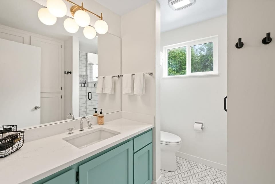 Freshen up in this stylish upstairs bathroom featuring contemporary design and plenty of counter space.