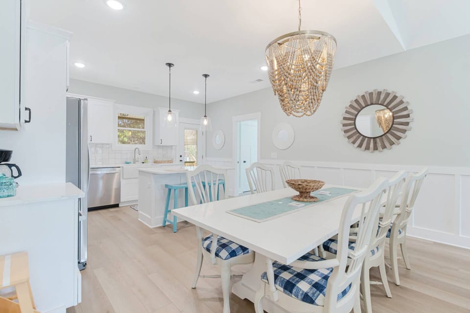 Dining table has seating for 8-10 with dining bench and 6 cushioned chairs just waitng to host a large family meal!