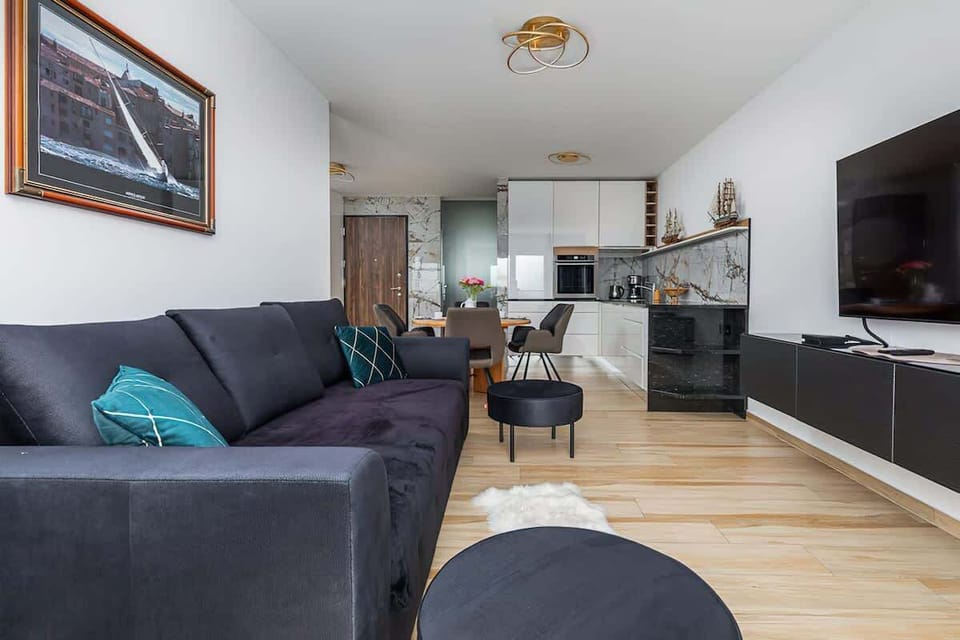 Living room with an emphasis on neutral tones and a chic blue accent sofa, giving a modern vibe.