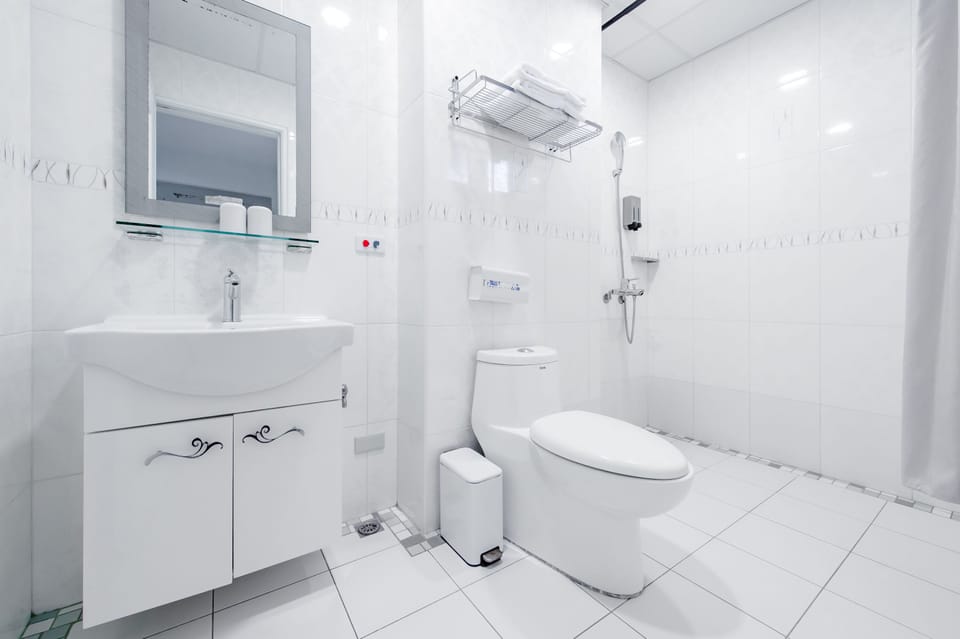 Shower, hair dryer, slippers, towels