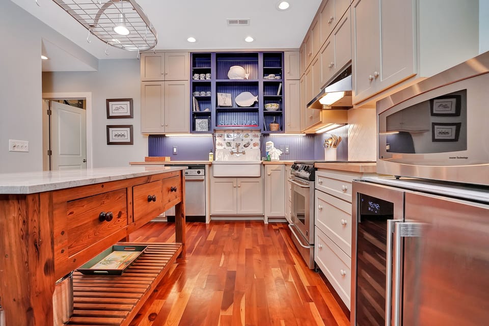This gourmet kitchen invites you to create memorable meals with premium appliances, granite countertops, and elegant wood cabinetry throughout your stay.