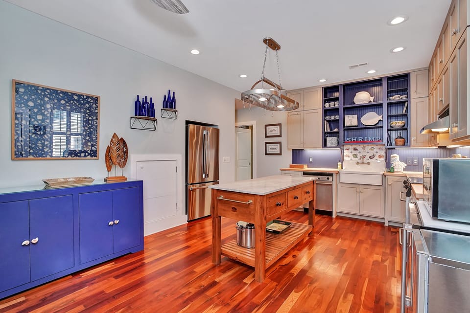 Your gourmet kitchen awaits with gleaming hardwood floors, granite countertops, and a charming island perfect for cooking memorable meals together.