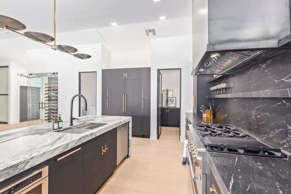 Custom stone counters and backsplash and high end appliances