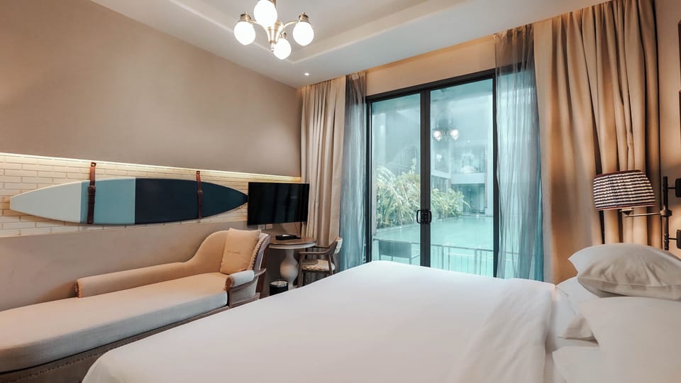 Deluxe Room, Pool Access | In-room safe, desk, blackout drapes, iron/ironing board