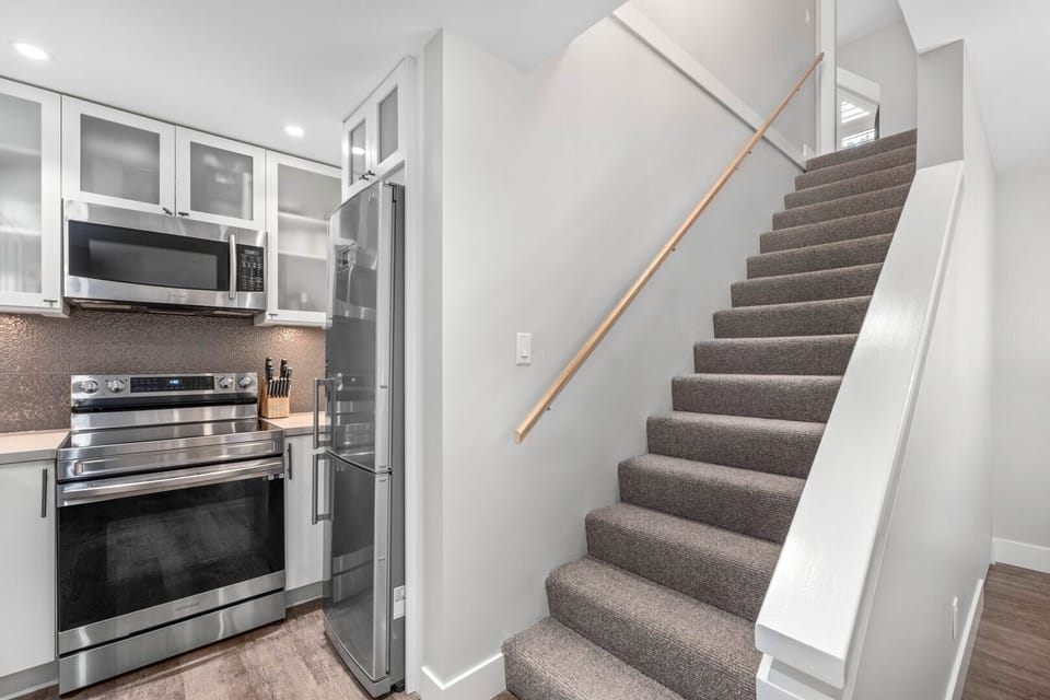 Fully equipped kitchen with stainless steel appliances—everything you need for home-cooked meals.
