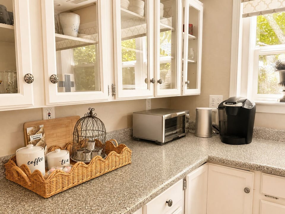 Coffee station with Keurig, electric kettle, and toaster for added convenience.