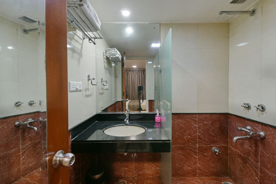 Deluxe Room | Bathroom | Shower, rainfall showerhead, designer toiletries, towels