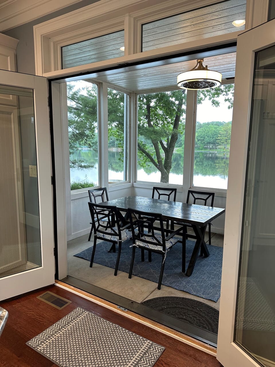 Screen porch with outdoor dining table.
