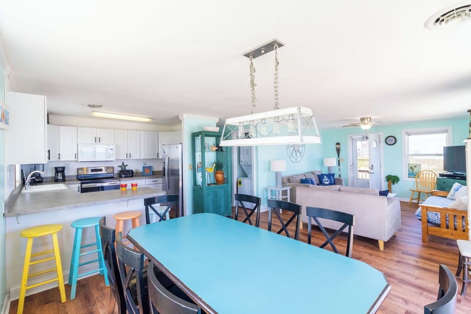 Dining Area - Grab a meal, plat a board game or just watch the waves all from this bright and coastal dining room table.