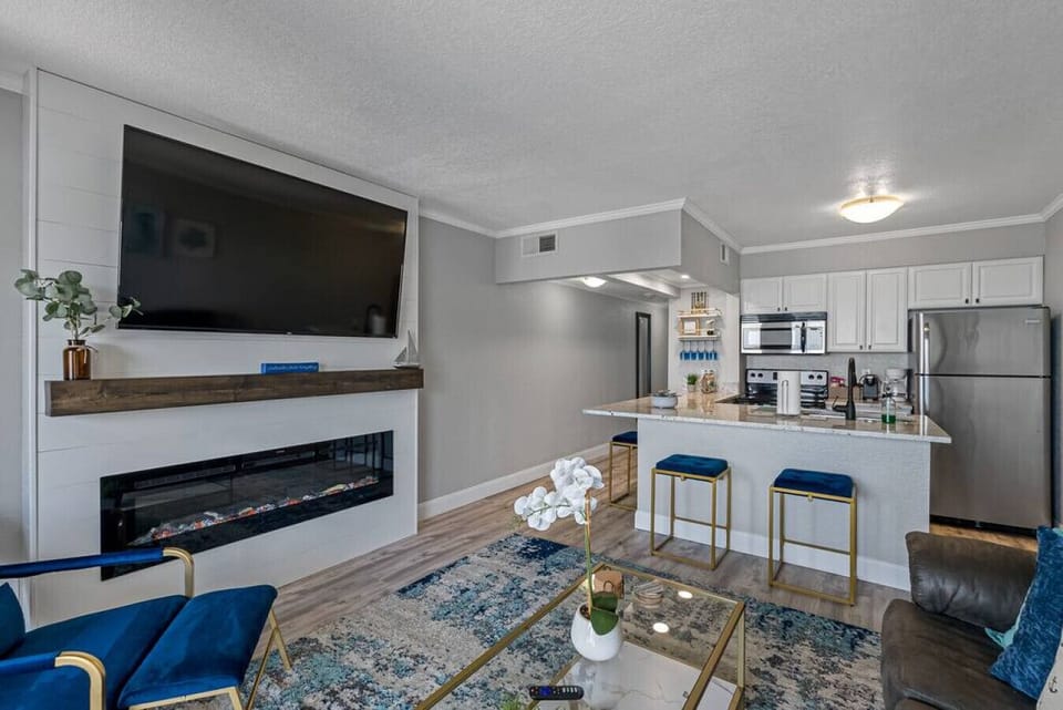 In the living room, you`ll find a beautiful and large sofa, along with a big television.