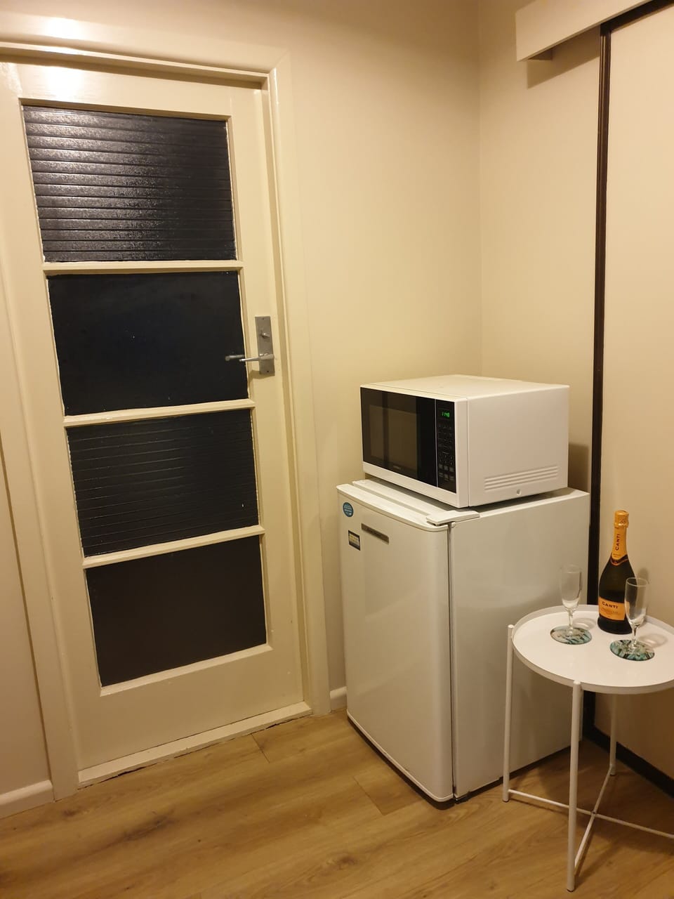 Kitchenette entrance with fridge and microwave