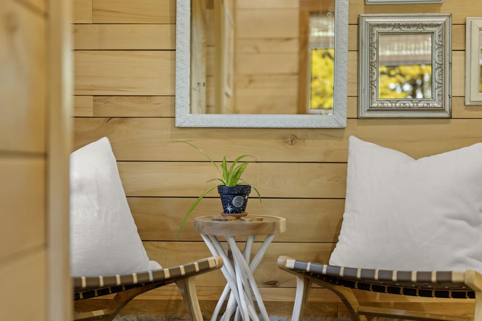 Bedroom 2 sip morning coffee from the mid-century modern woven chairs.