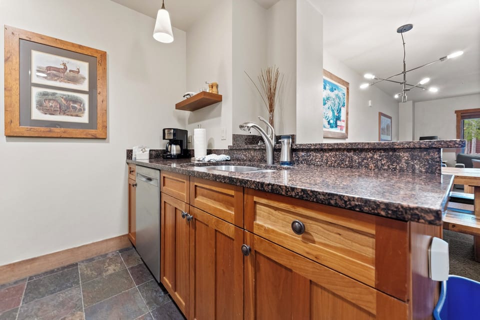 Your fully equipped kitchen features granite countertops, warm wood cabinetry, and quality appliances for preparing memorable meals together.