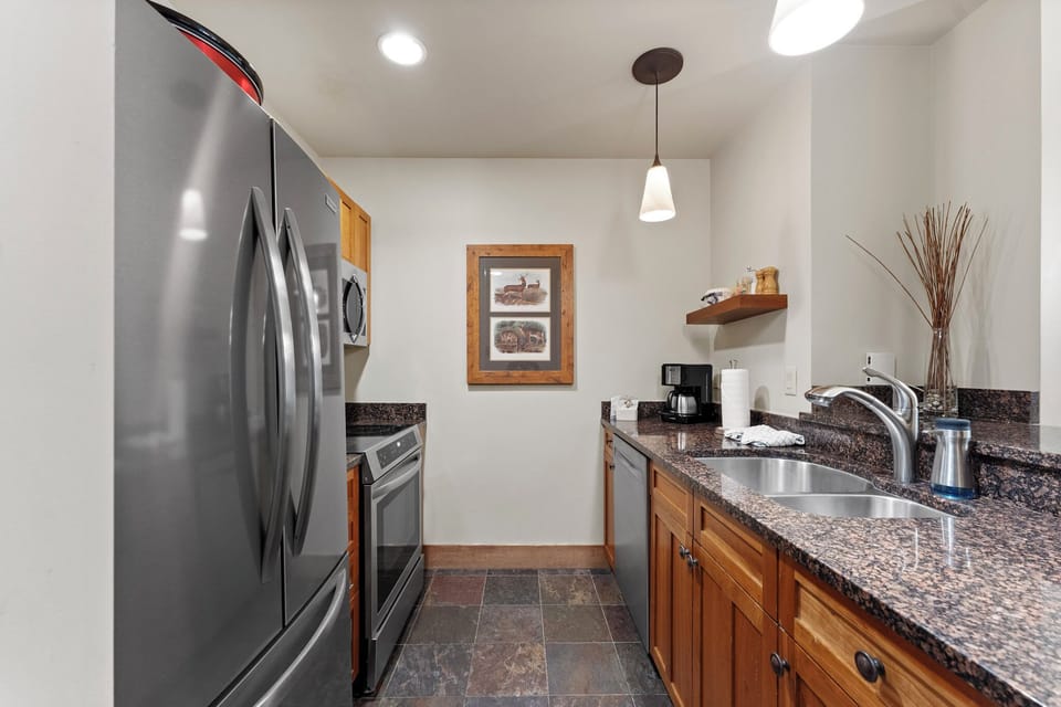 Your fully-equipped kitchen features stainless steel appliances and granite countertops, perfect for preparing meals during your mountain getaway.