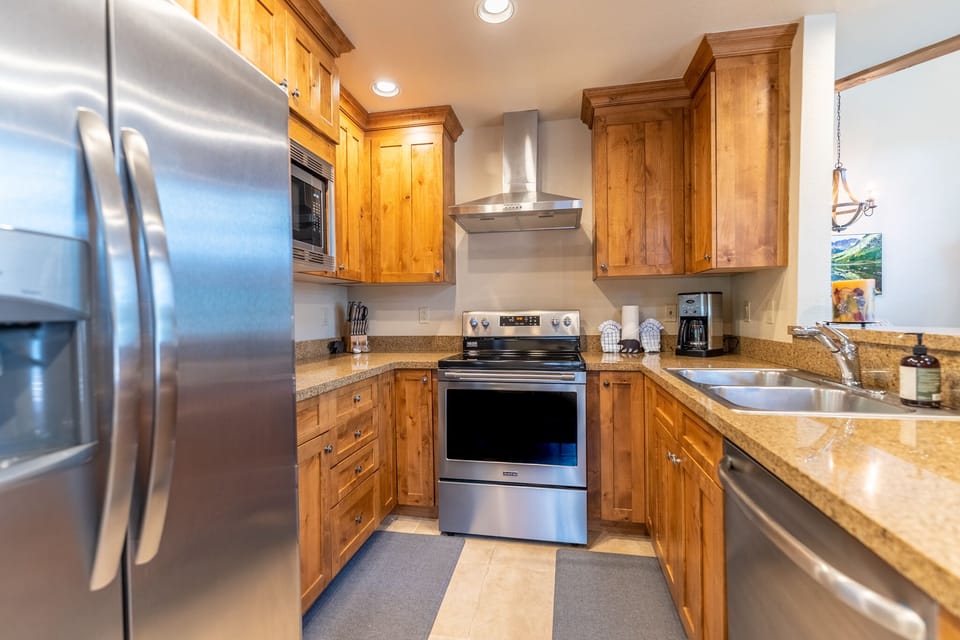 Your fully-equipped kitchen features warm wood cabinets, granite counters, and stainless steel appliances—perfect for preparing memorable meals together.