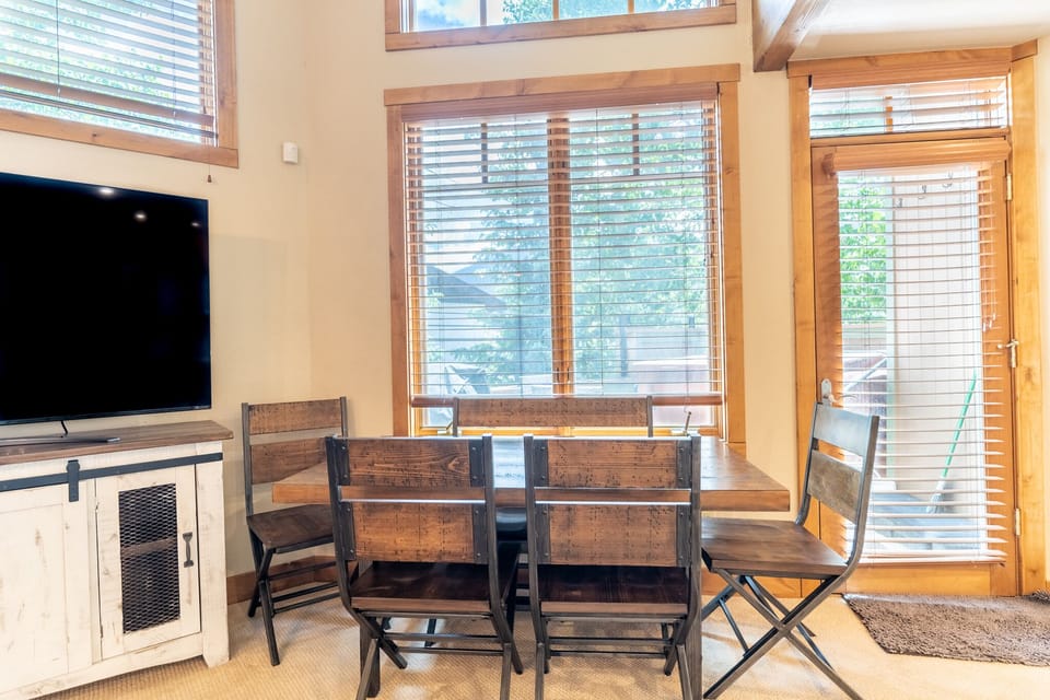 Gather around your rustic dining table for memorable meals, with warm wood finishes and large windows filling your space with natural light.