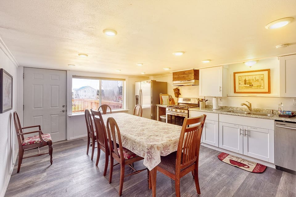 The dining area showcases a wooden table with seating for six.