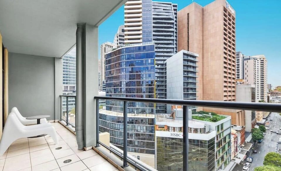 Private balcony with outdoor seating and elevated city outlook.