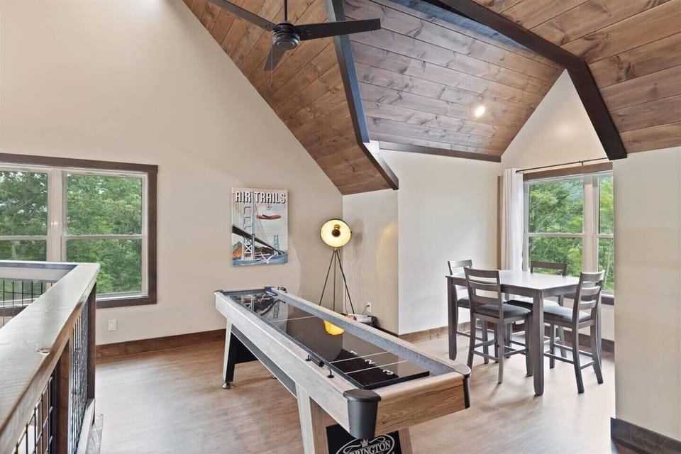 Upper level game loft with shuffleboard table and a gathering table for boardgames!