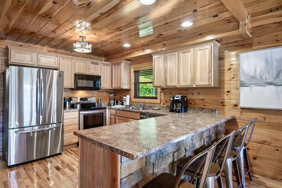 Fully stocked kitchen with breakfast bar and updated appliances.