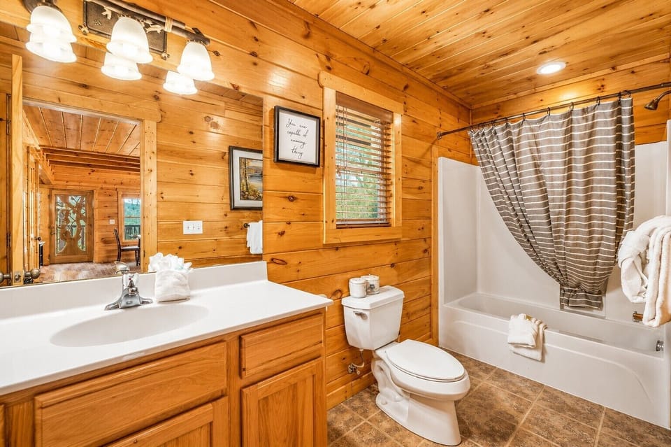 First floor bathroom with bathtub and shower.