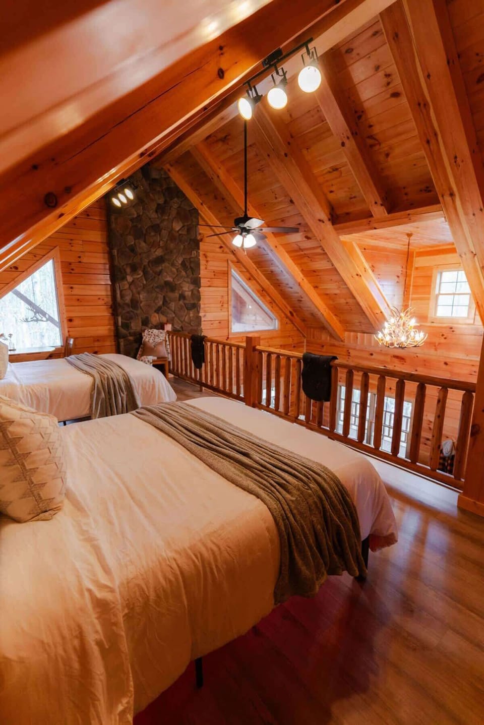 Loft Bedroom: Experience rustic charm with double beds and stunning wood accents!