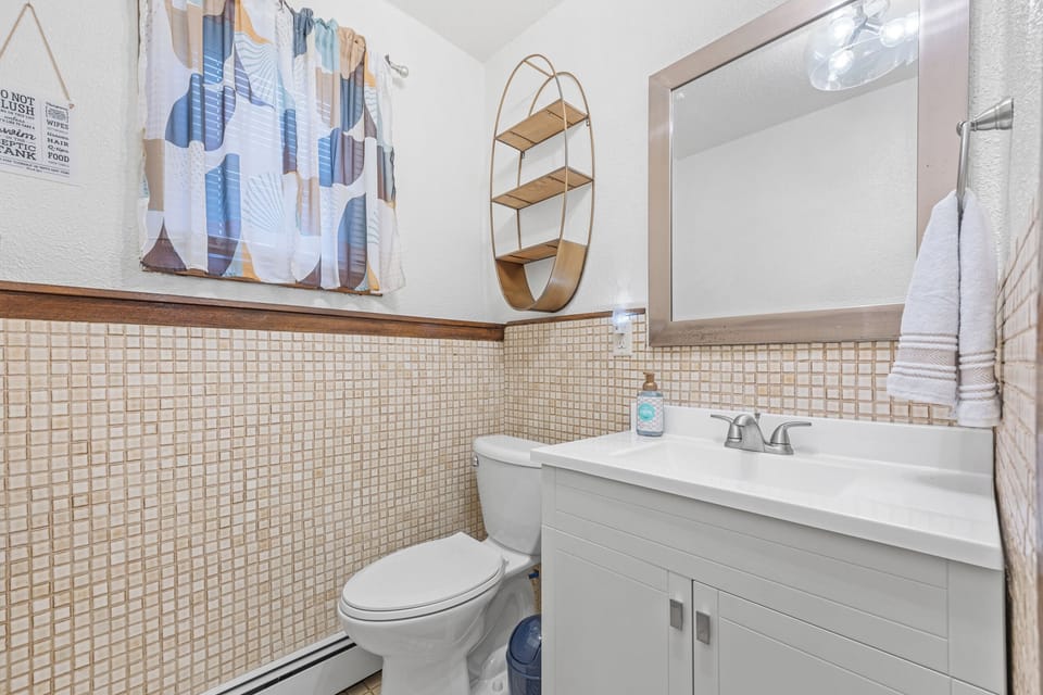 Bathroom in basement walk-out. Fresh hand & bath towels. Makeup remover cloth