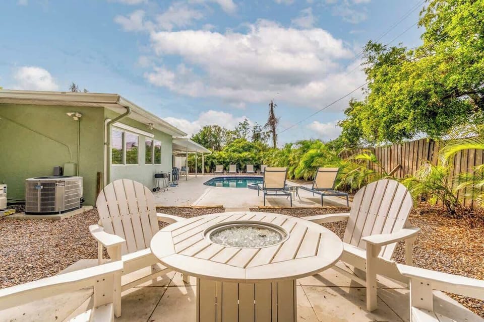 Fire pit area with Adirondack chairs.
