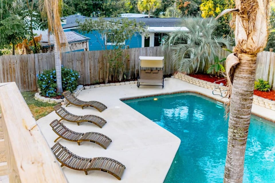 Outdoor saltwater pool has plenty of seating to soak up the sun