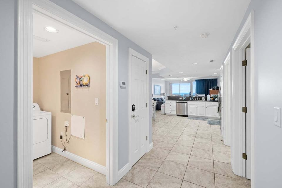 The entrance opens into a bright hallway that has a washer and dryer area, making it easy to handle laundry during your stay