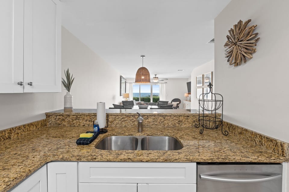 Thanks to the open floor plan, the kitchen flows seamlessly into the living area, allowing guests to stay connected while prepping snacks or sipping wine at the eat-in bar.