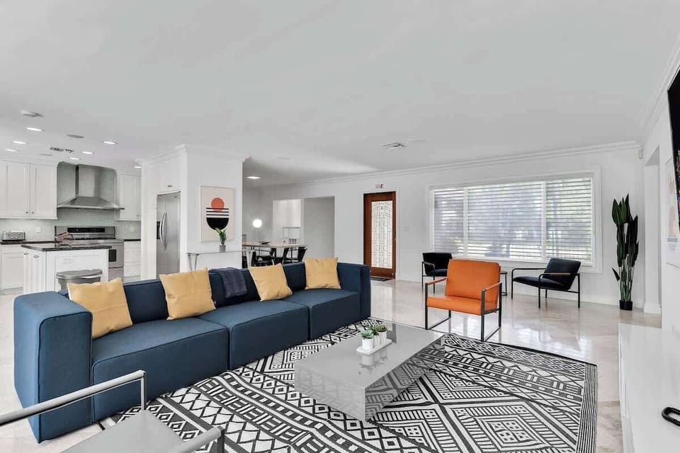 Open-concept living meets modern style—perfect for vacation rentals and short-term stays. Enjoy a bright space with comfy seating, sleek kitchen, and vibrant decor designed for relaxing getaways and group gatherings.