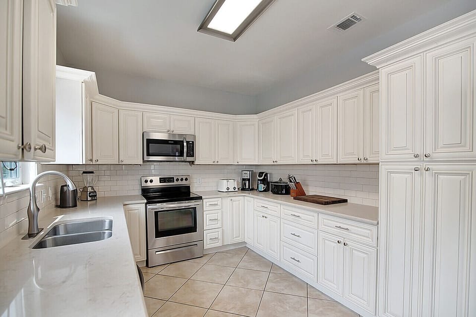 The spacious kitchen has plenty of cabinet and counter space for meal prep