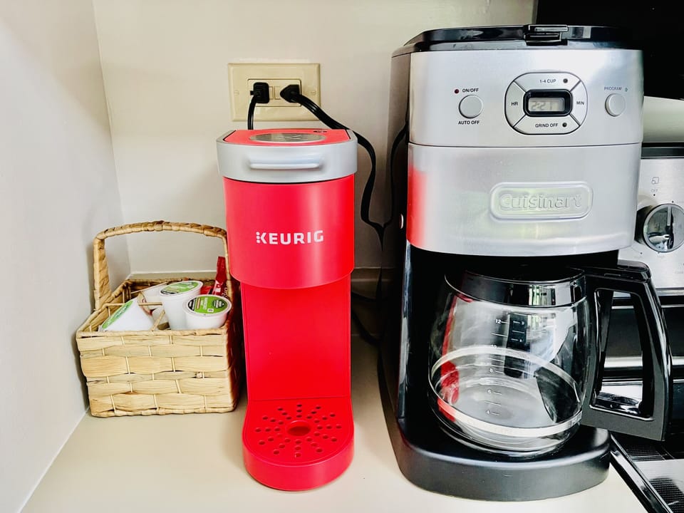 Initial supply of Keurig pods, coffee, creamer, tea, and condiments.