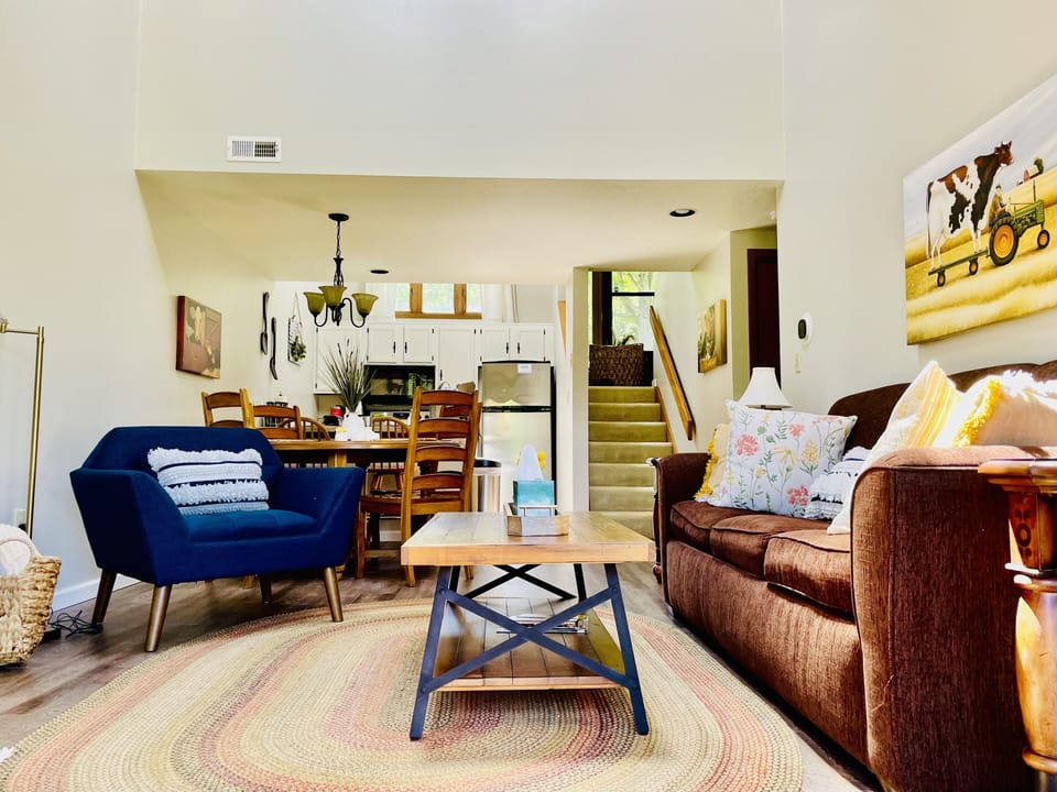 Stairs from the living room lead to the upper-level bedroom.