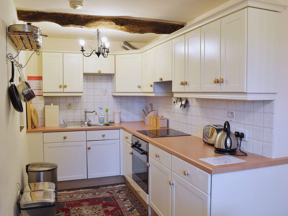 Well-equipped beamed kitchen with flag flooring and plenty of cupboard space | Dewsnaps Frost - Dewsnaps, Chinley, near Chapel-en-le-Frith