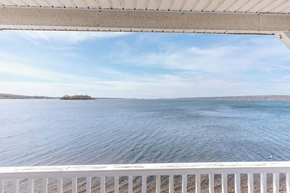 Directly on the water! Backyard private rock beach. View from second floor deck off back of house.