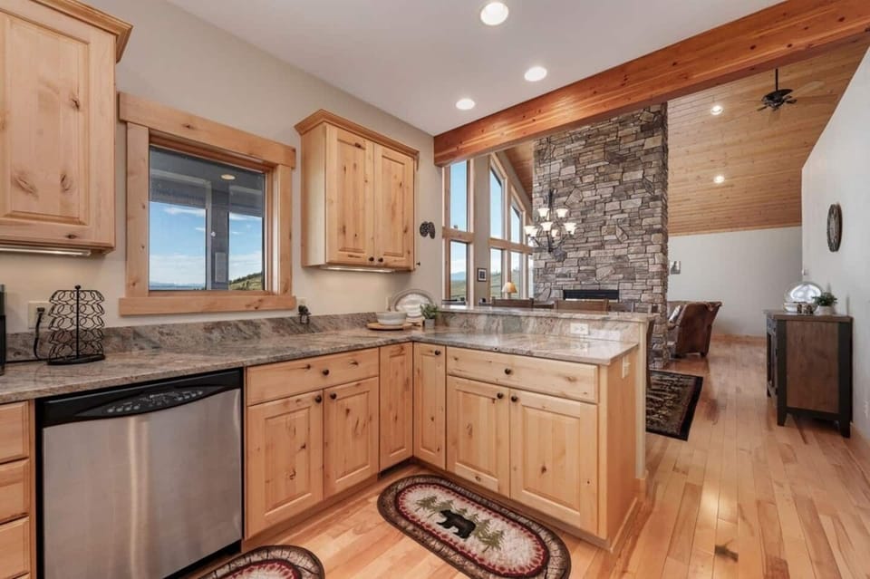 Kitchen open to dining and split share fireplace. 