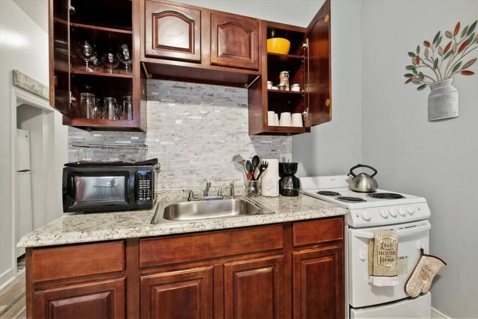 Stylish kitchen with a sleek design, complete with cookware and utensils for your convenience.