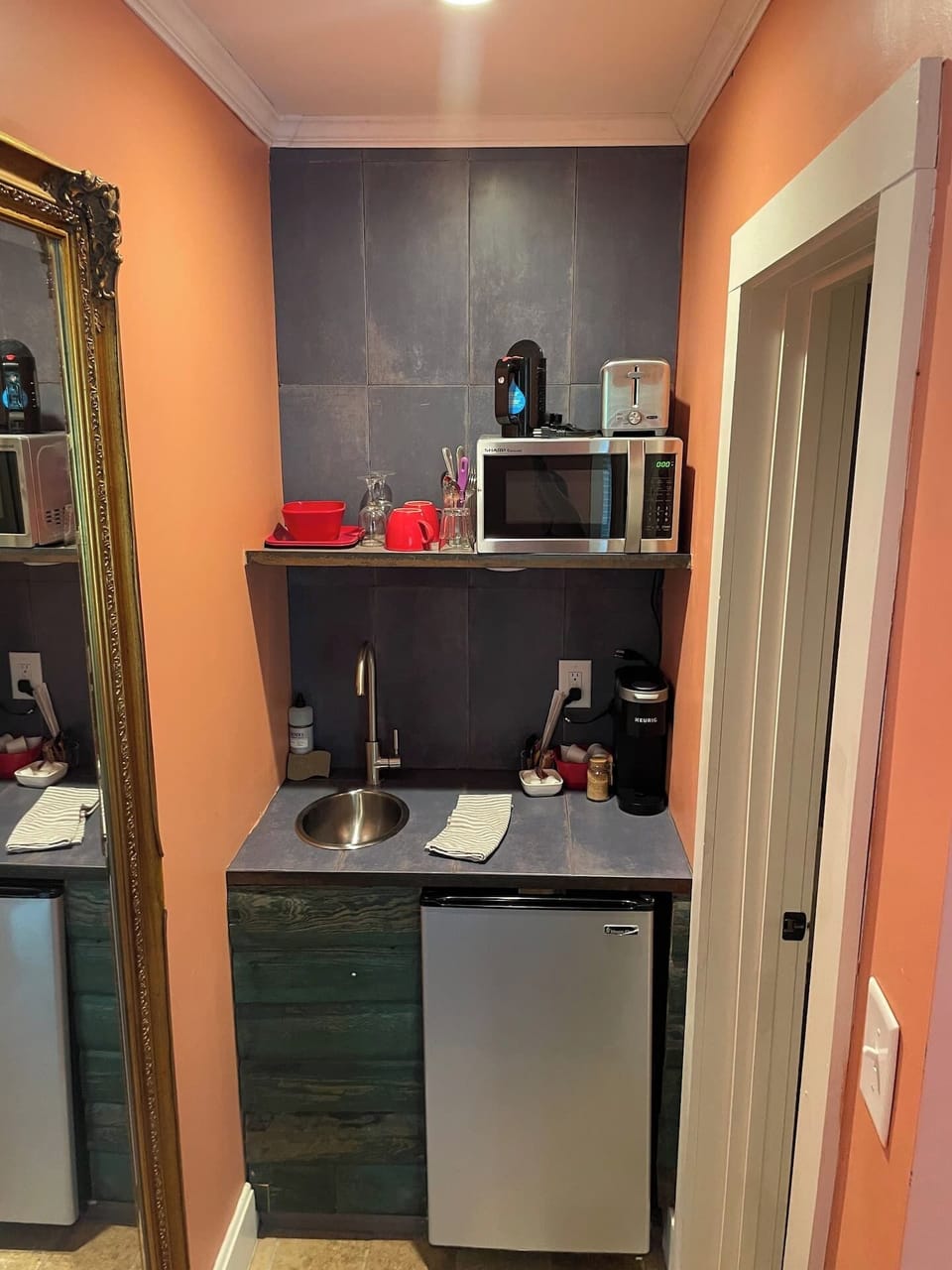 Kitchenette with toaster, kettle, microwave, Keurig coffee maker, With coffee pods, sugar and creamer.