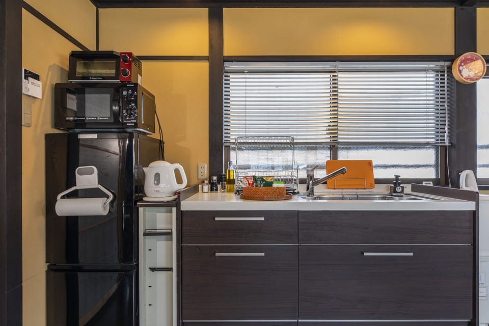 Comfort Townhome | Private kitchen | Full-size fridge, microwave, stovetop, electric kettle