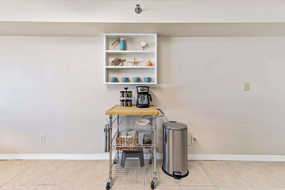 Drip coffee pot with coffee, cream and sugar provided. 