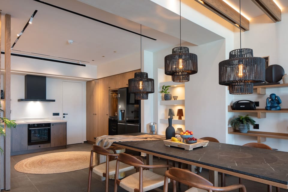 The living area has a long wooden dining table that seats 8 guests!