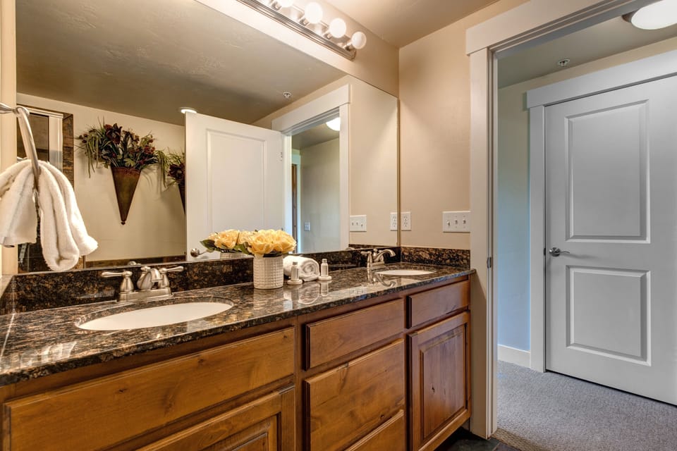 Master Bathroom with double sinks, jetted tub, and tile & glass shower