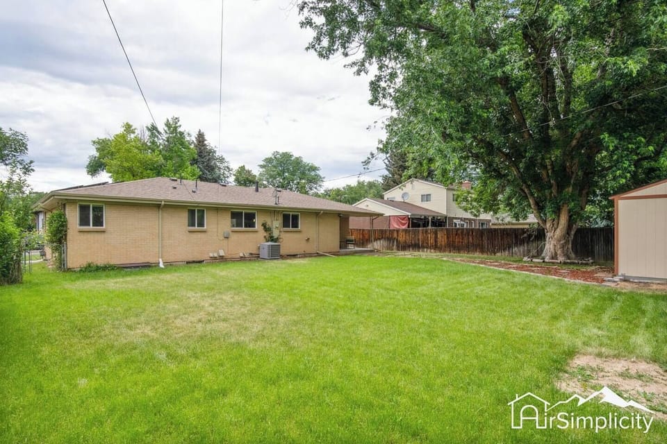 Relax and enjoy the great outdoors in our spacious fenced-in backyard, complete with patio furniture and string lights.
