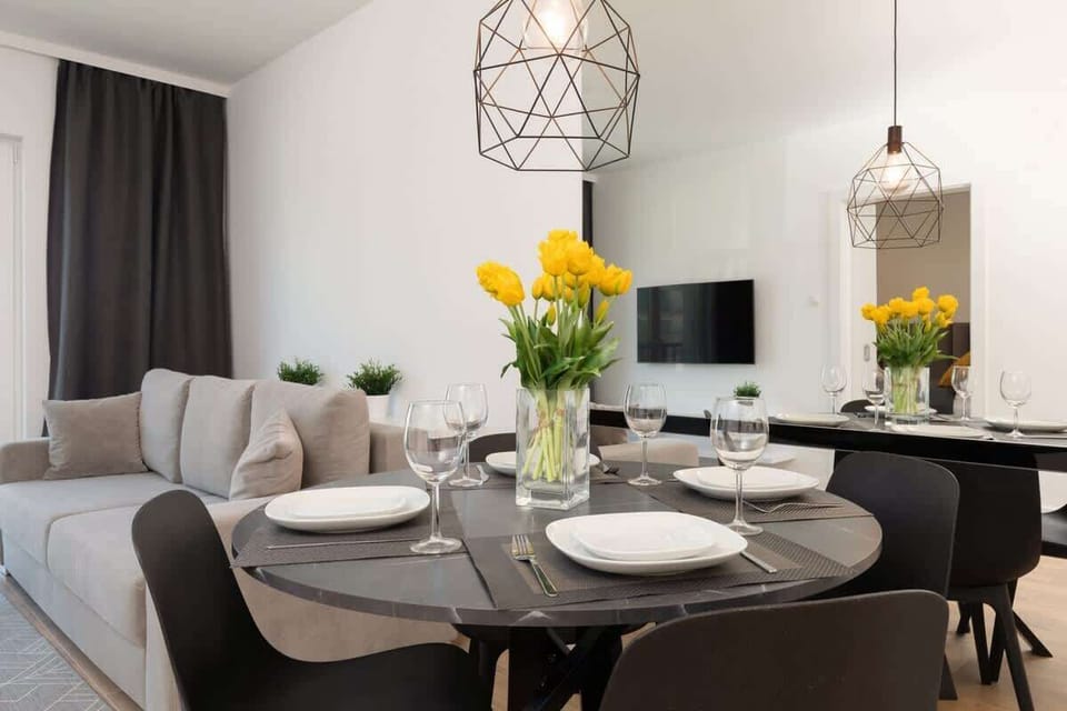 The elegant living room featuring a double sofa bed, perfect for relaxing or sleeping.