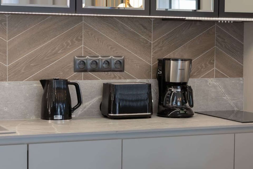 The sleek design of the kitchenette blending seamlessly with the living area.
