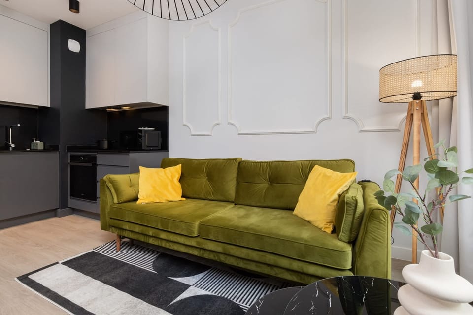 The living area features a sleek coffee table and a flat-screen television.