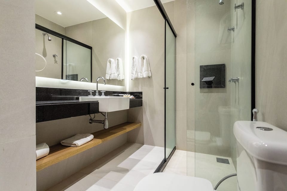 Shower, designer toiletries, hair dryer, towels