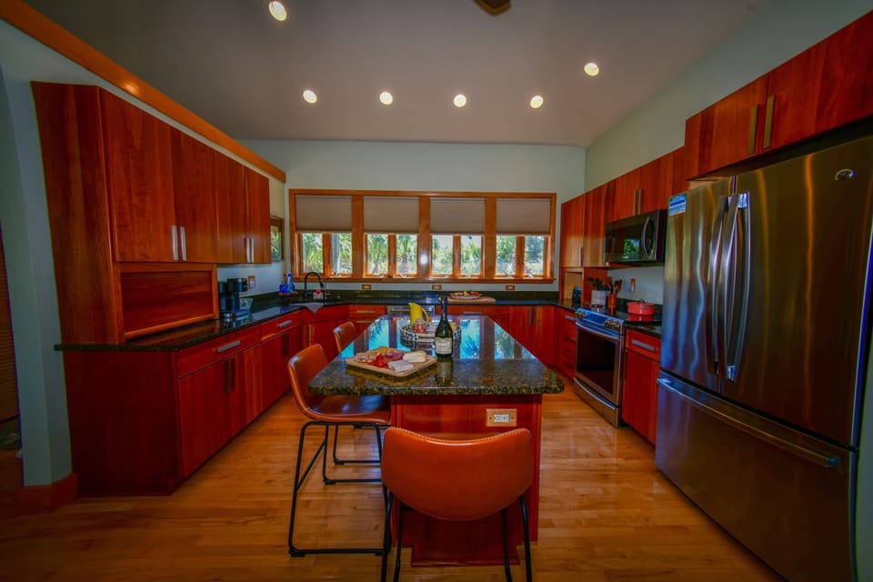 Spacious chef's kitchen with granite counters and bar seating